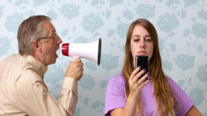 Father shouting at daughter texting